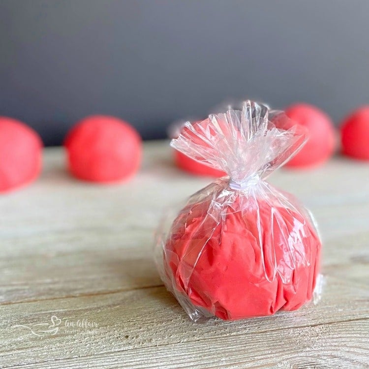 A piece of play doh wrapped in cellophane