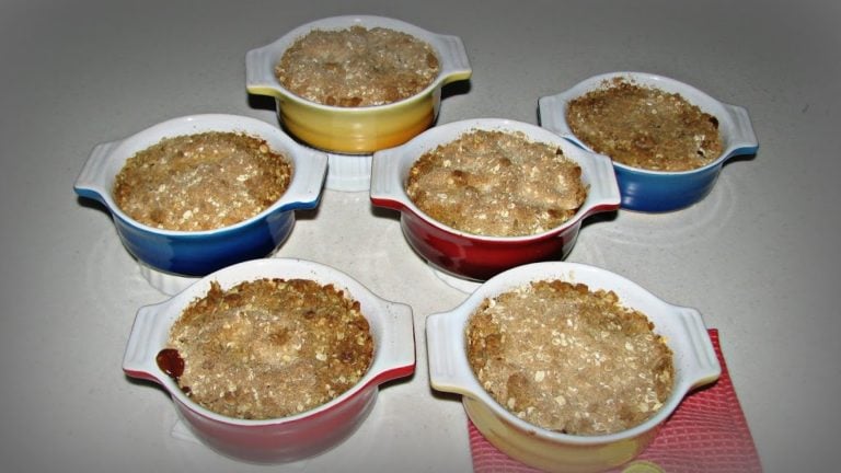 6 individual peach crisps on a table