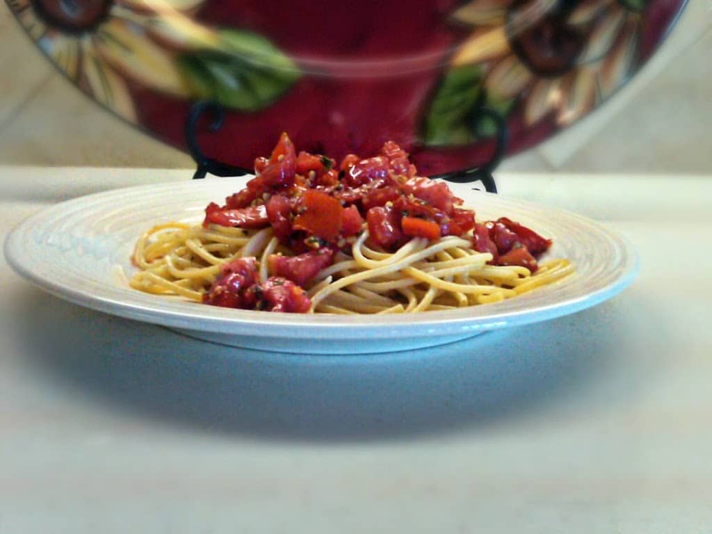 side view of pasta pomodoro ina white bowl