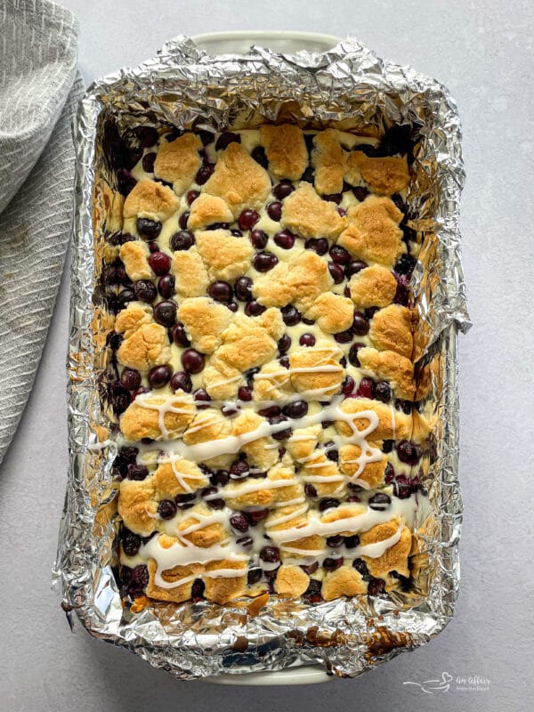 drizzle glaze on warm blueberry crumble bars