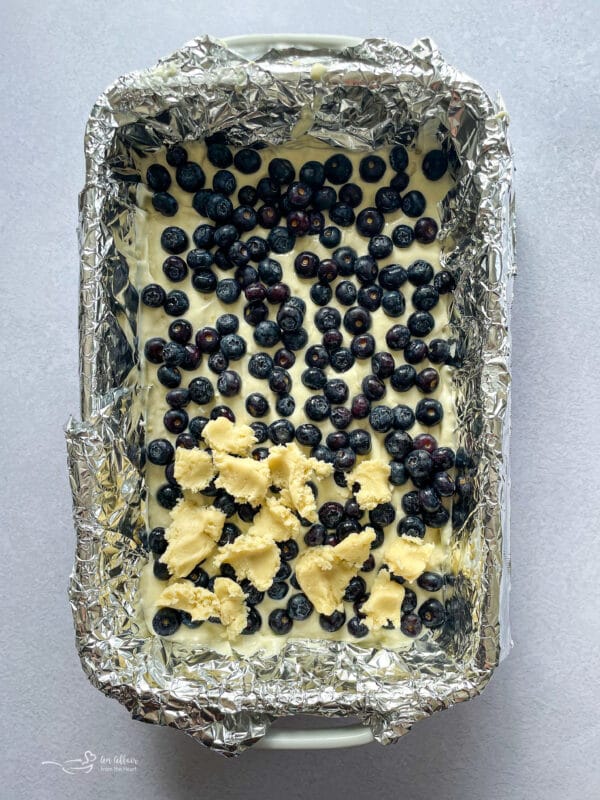 adding blueberries to unbaked cake mix