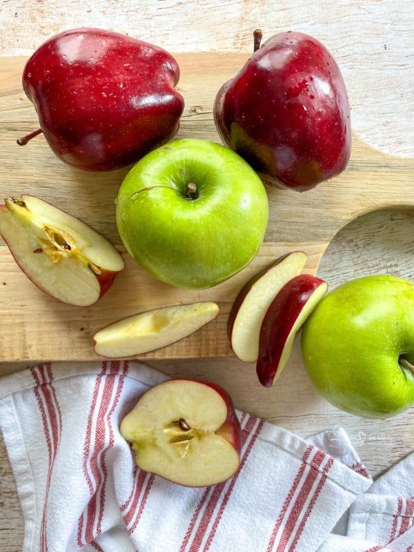 green and red apples on cutting board