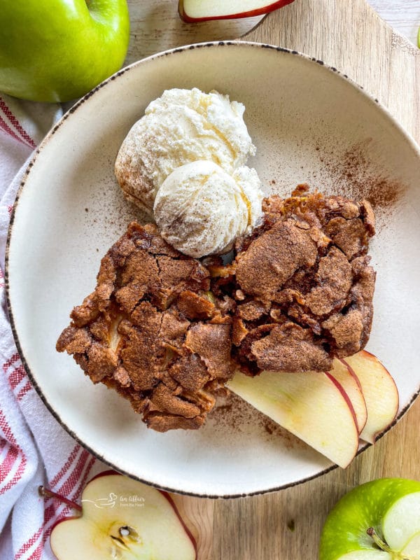 close view of apple cake with apples and ice cream