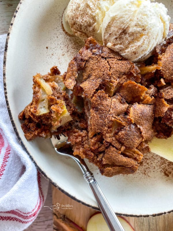 close view of apple cake with fork and ice cream