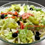 Copy cat Olive Garden Salad in a clear serving bowl
