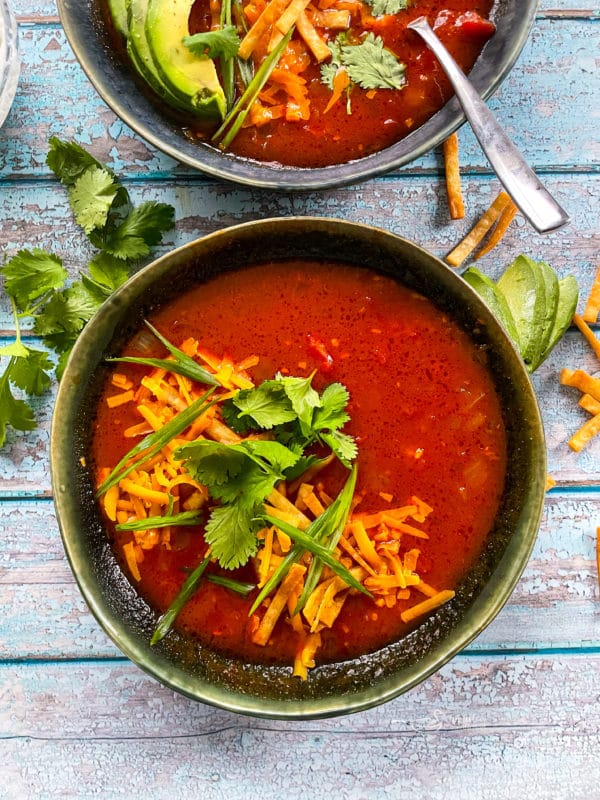 tortilla soup with cheddar cheese and herbs