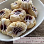cookies in a white bowl with text "almond raspberry shortbread thumbprints"