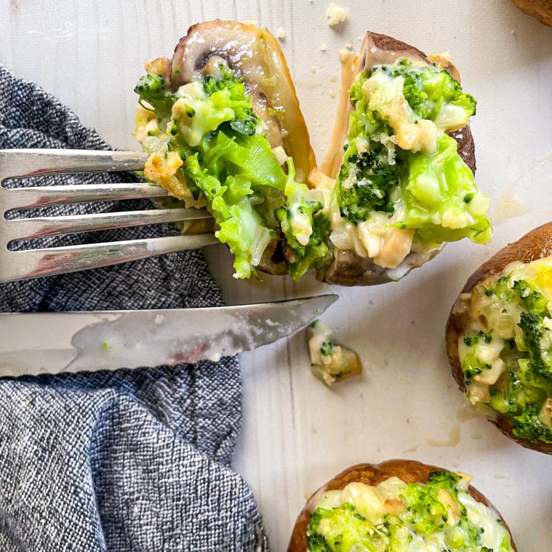 slicing mushroom in half with broccoli 