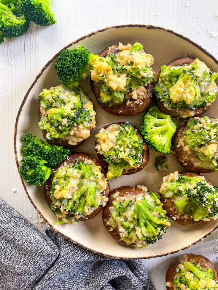 one plate of stuffed mushrooms with cheese and broccoli