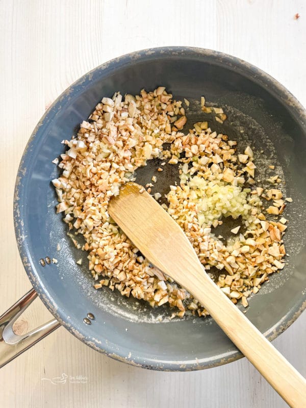 pan with mushroom stems and onion 