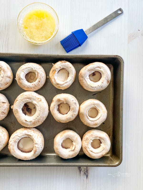 mushrooms on baking sheet with butter