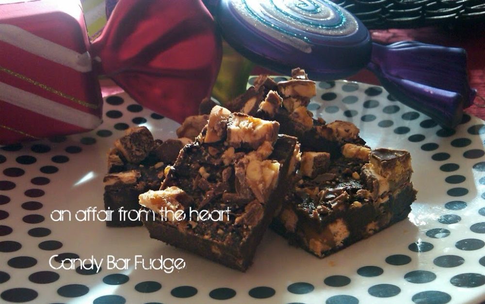 side view of candy bar fudge on a white plate with polka dots on it