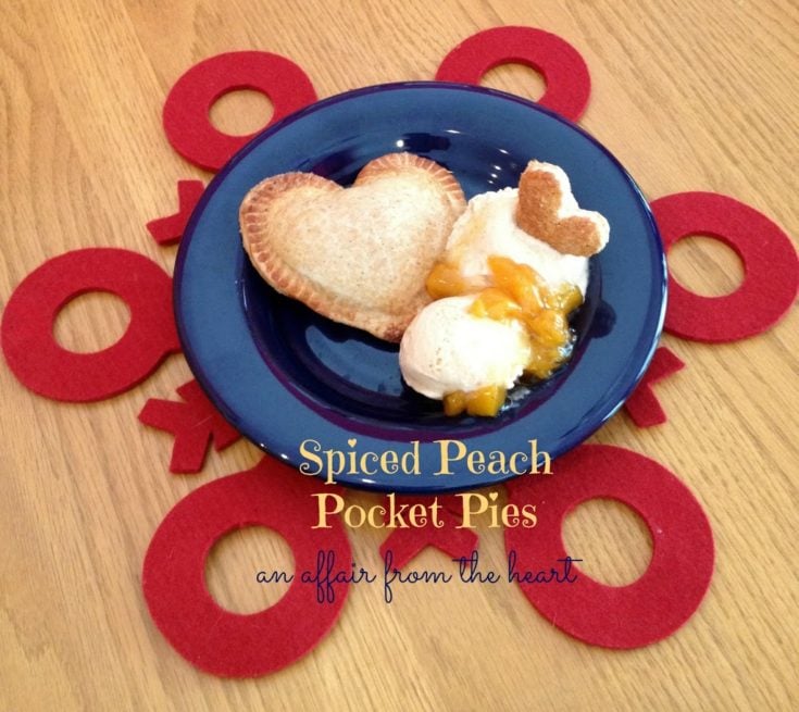 spiced peach pocket pies with vanilla ice cream on a blue plate