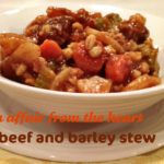 Close up of Beef and Barley stew in a white bowl