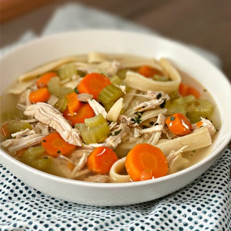 close up of Homemade Chicken Noodle Soup in a white bowl