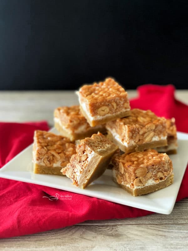 Salted Nut Roll Bars stacked on a white plate