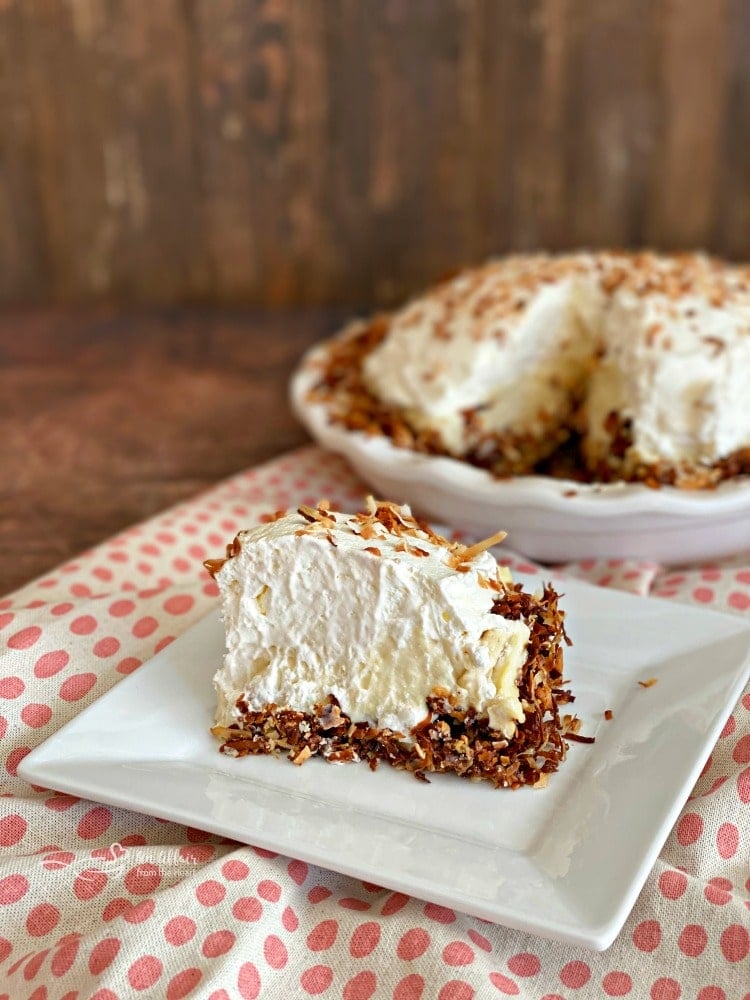 sliced Coconut Banana Cream Pie on a white plate