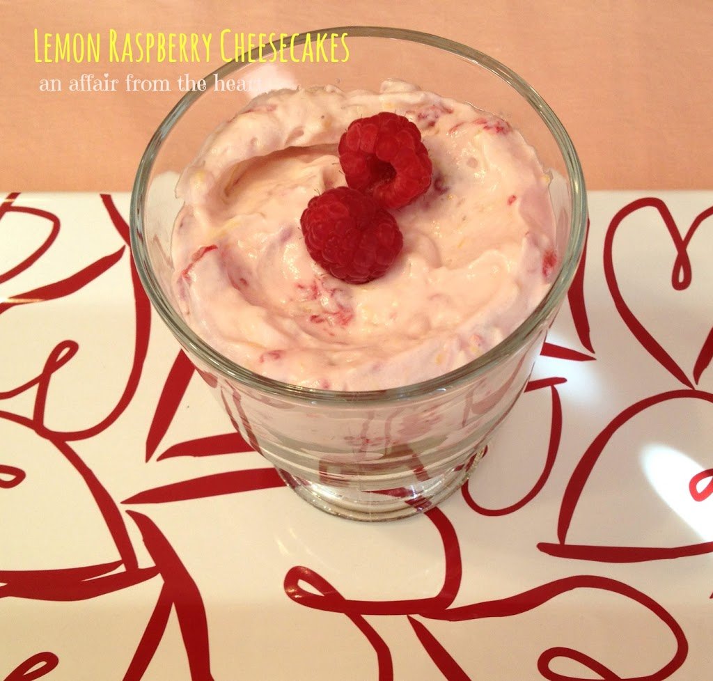 overhead of cheesecake in a glass with text "lemon raspberry cheesecakes"