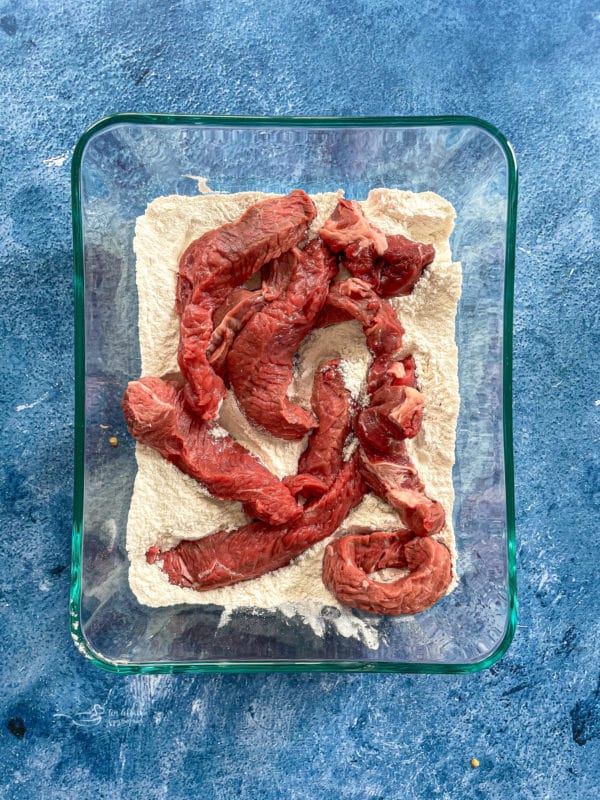 Steak being seasoned