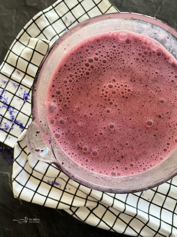 Top view of blended purple cow smoothie in blender