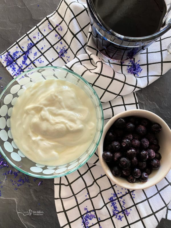 Top view of yogurt, blueberries, and grape juice