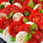 Caprese Salad (Tomatoes with Mozzarella and Basil) on a white plate