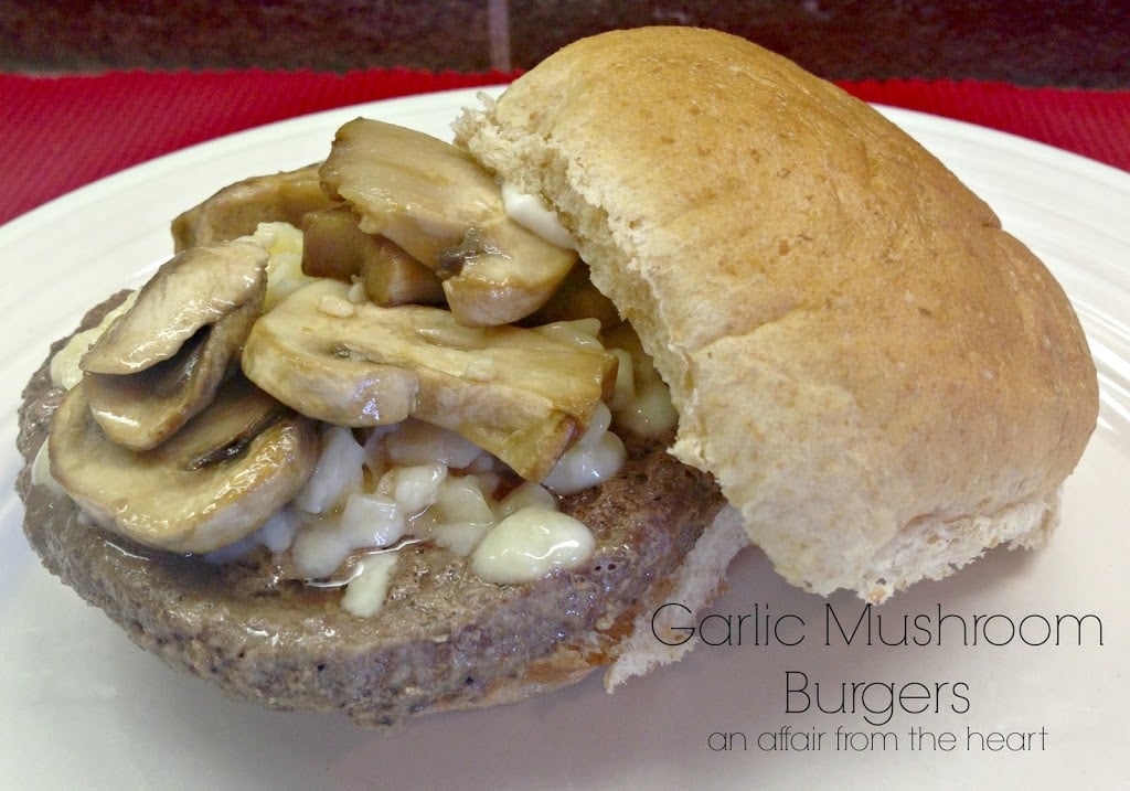 close up of burger on a white plate with text "Garlic Mushroom Burgers"