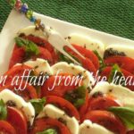 Close up of mozzarella and tomatoes on a white platter