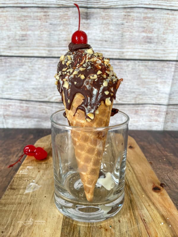 One homemade drumstick in glass with cherry on top