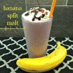 Banana split malt in a large glass with a straw with a banana next to it and text 'banana split malt"