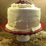 Cherry torte cake on a white cake plate