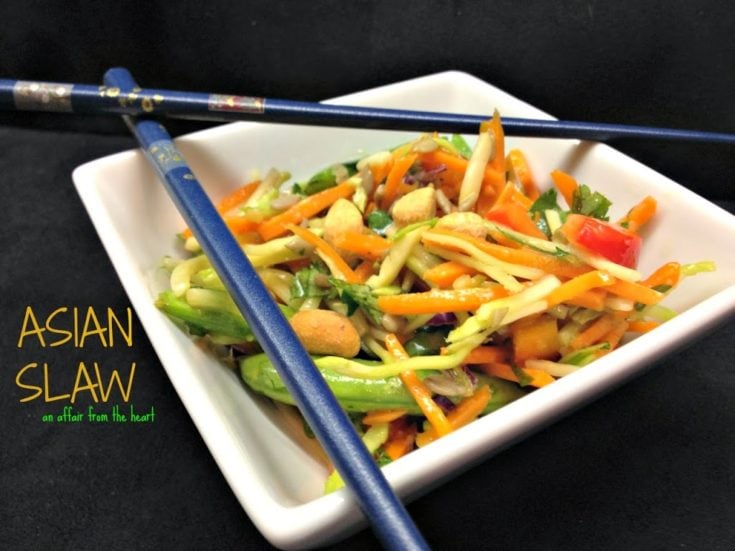 Asian Slaw in a white square bowl with chopsticks laying on top and text