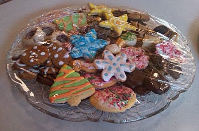 variety of Christmas cookies on a clear serving plate