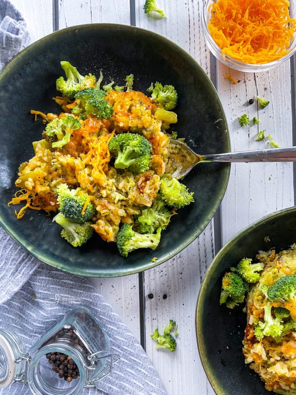 Two plates with broccoli and cheese casserole
