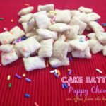 cake batter puppy chow on a red surface with text "cake batter puppy chow"