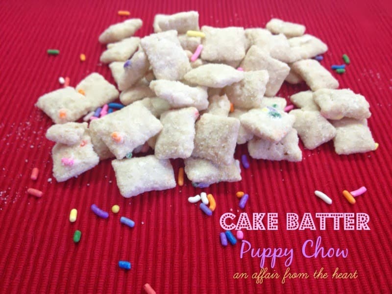 cake batter puppy chow on a red surface with text "cake batter puppy chow"