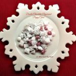 double chocolate peppermint puppy chow on a white snowflake serving platter