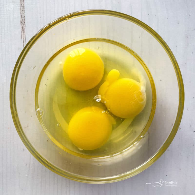 top view of three eggs in bowl