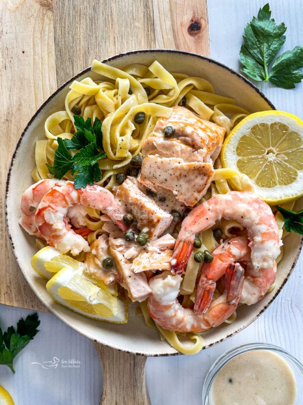 top view of lemon caper sauce with salmon and shrimp