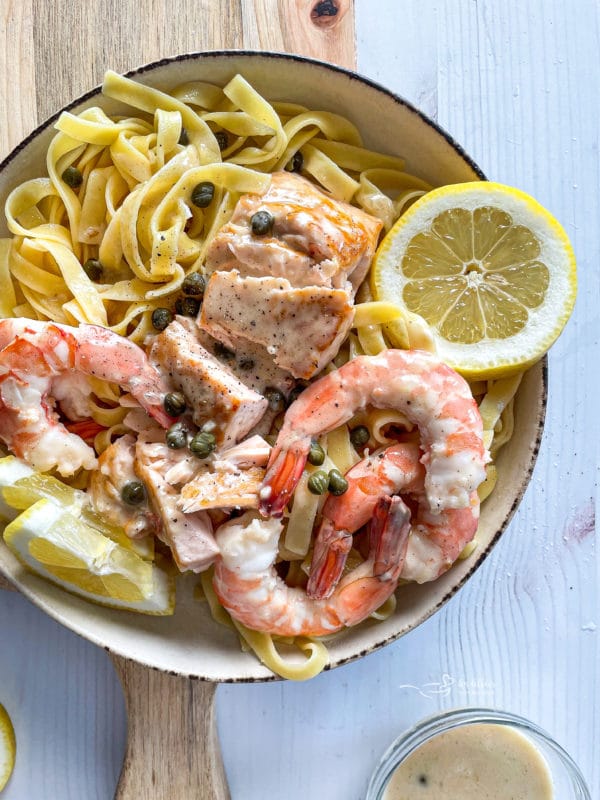 top view of lemon caper sauce over salmon and shrimp