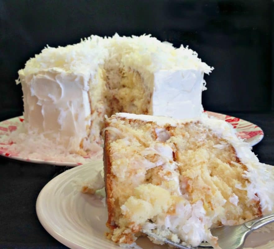 Coconut Cream Poke Cake with Coconut Whipped Cream Frosting