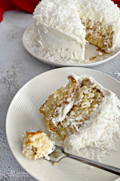 Coconut Cream Poke Cake with Coconut Whipped Cream Frosting