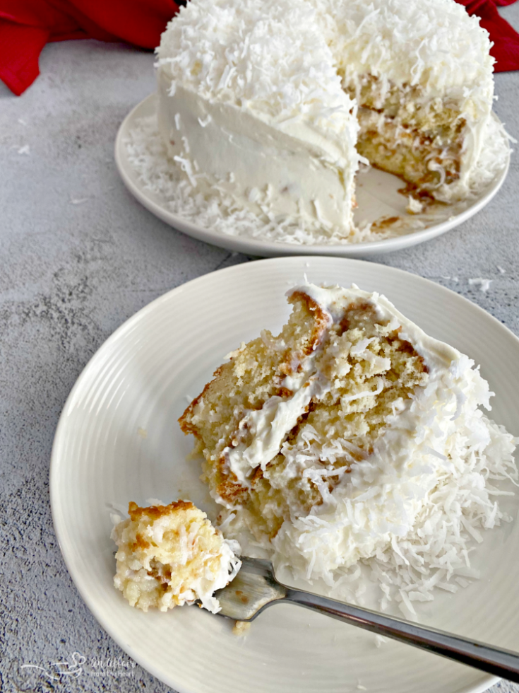 Coconut Cream Poke Cake with Coconut Whipped Cream Frosting