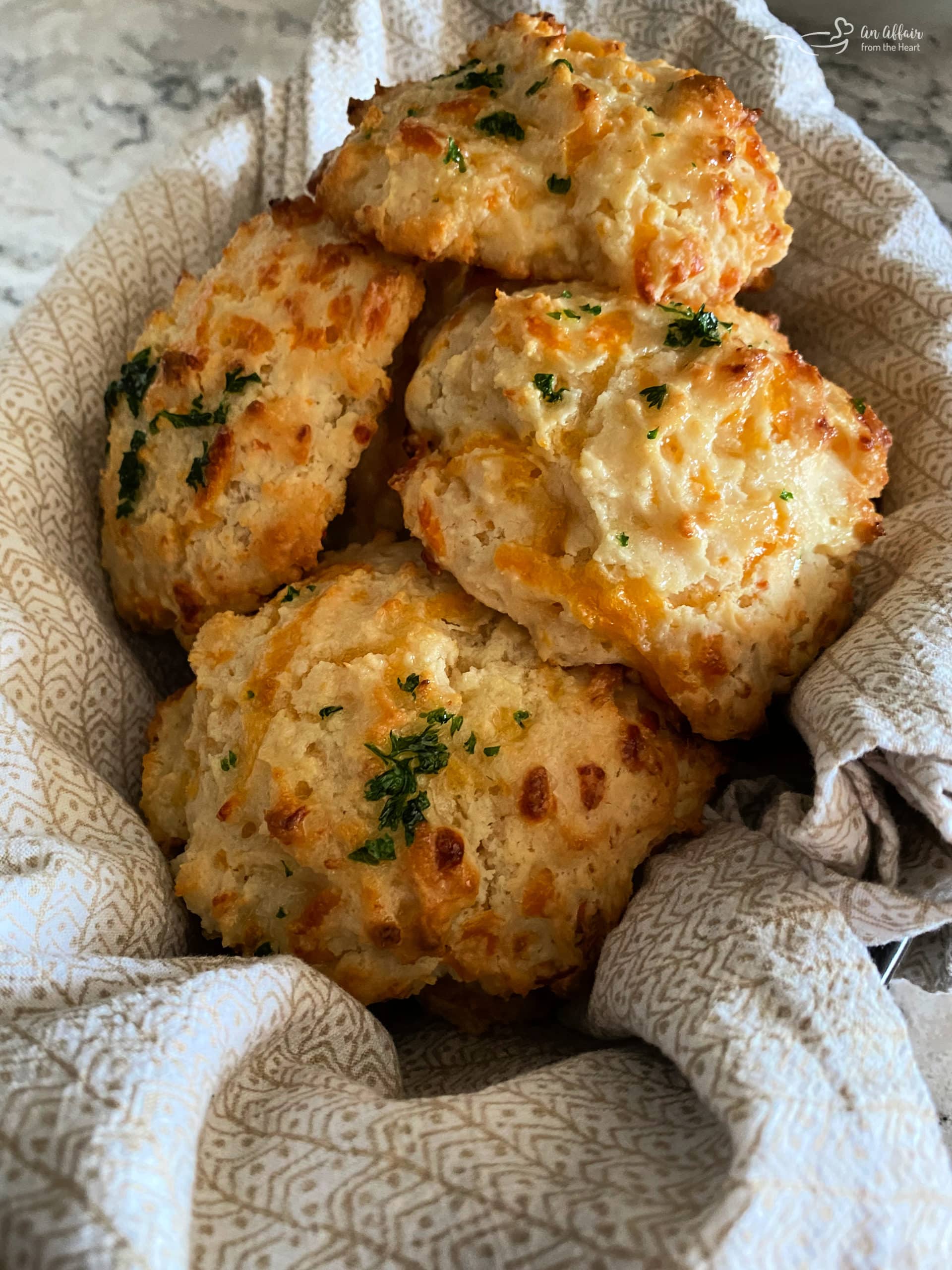 Five cheddar bay biscuits in basket