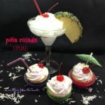 Cupcakes and a Pina colada cocktail on a black surface with text "Pina colada cupcakes"