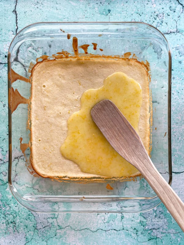 lemon glaze poured over brownies