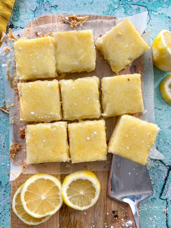 top view of lemon brownies on cutting board with lemons