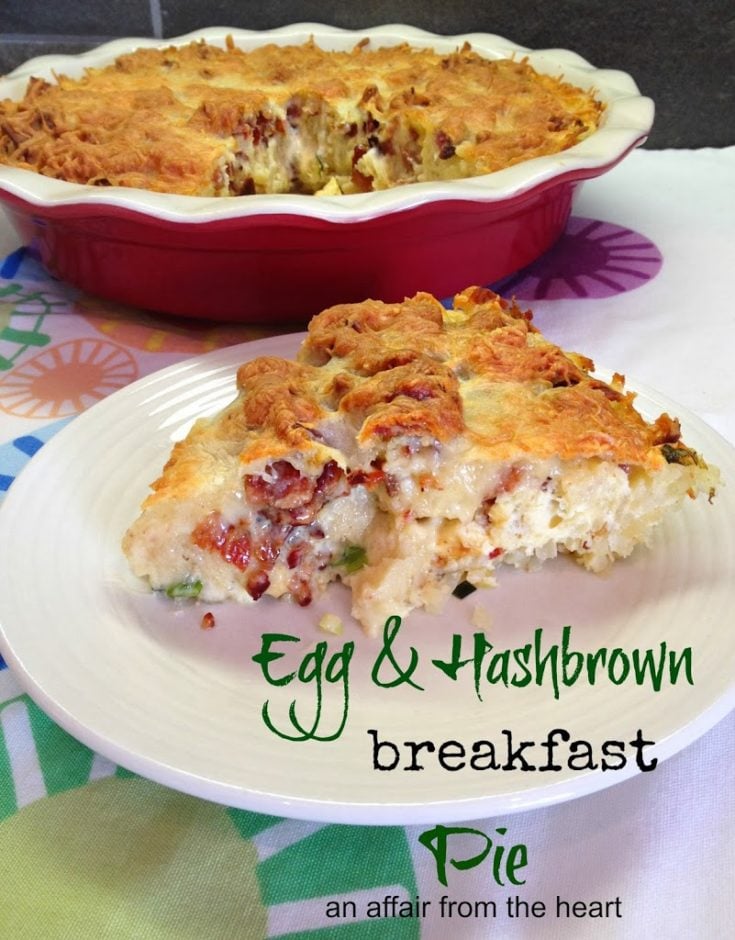 Egg & Hashbrown breakfast pie in a ceramic pie pan and a slice of the pie on a white plate both on a multi colored table cloth.