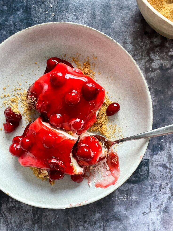 Close up of cherry desert on a fork.
