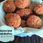 Banana Spice Crumb Muffins in a blue bowl lined with a green cloth napkin